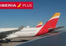 a group of airplanes parked at an airport