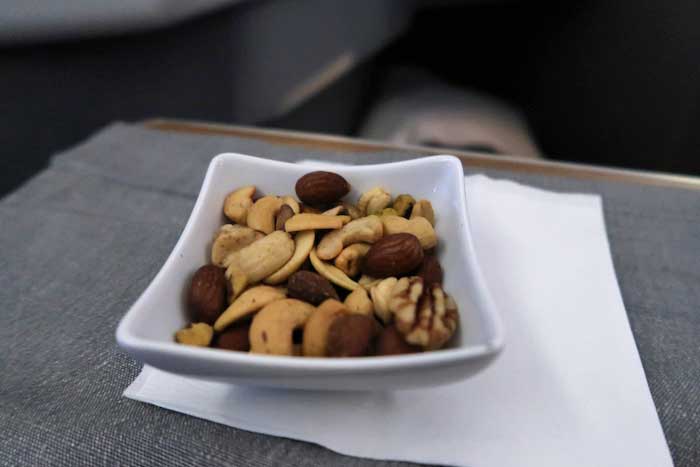 a bowl of nuts on a napkin