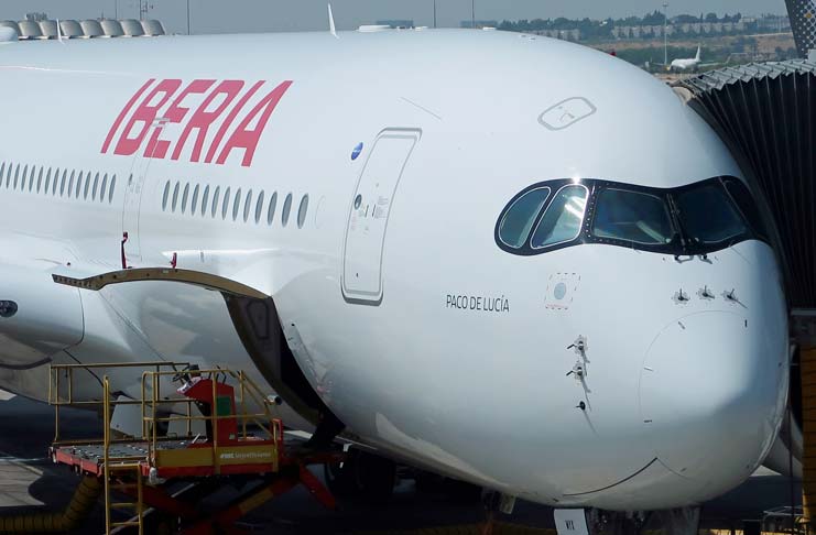 a large white airplane with red writing