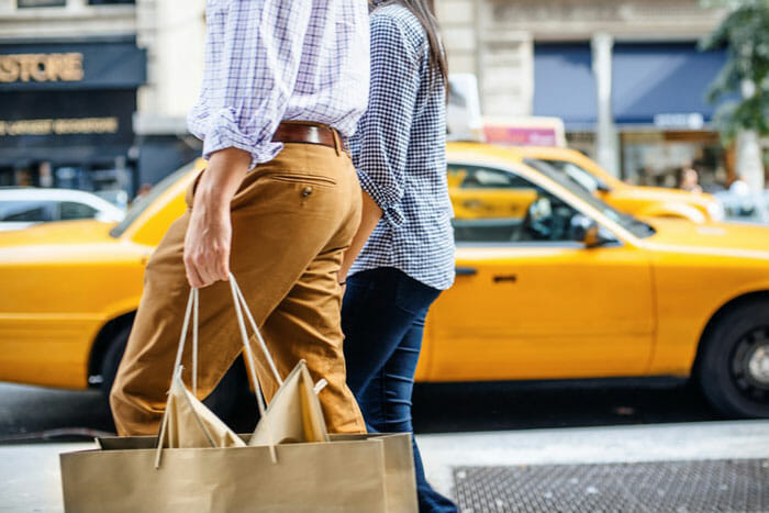 a man and woman carrying shopping bags