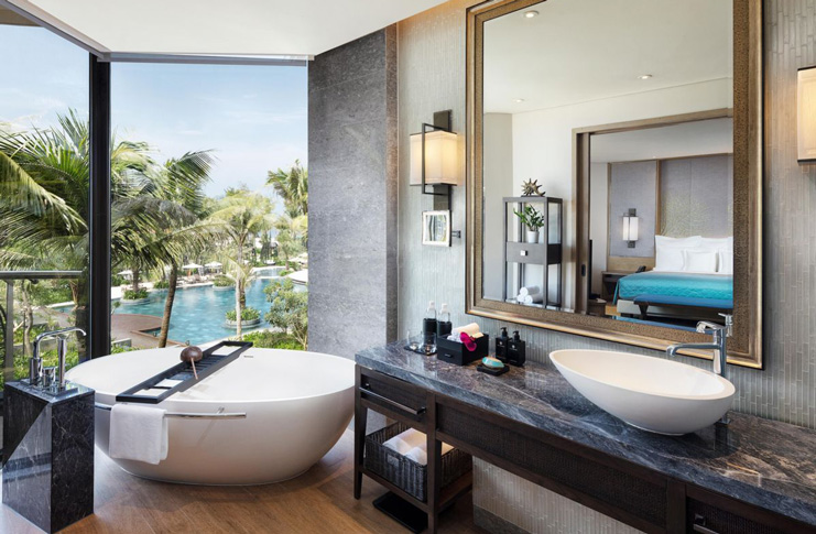 a bathroom with a large mirror and tub