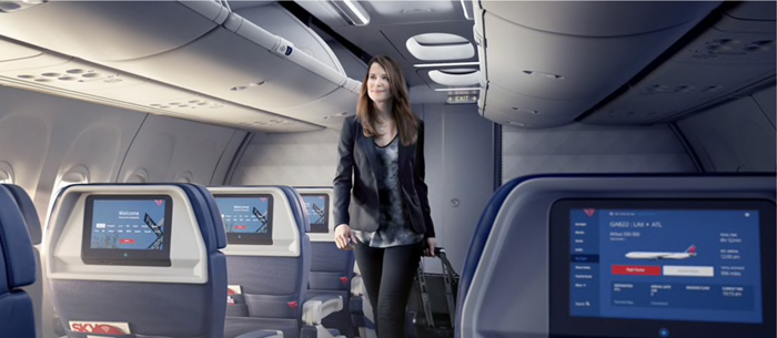 a woman walking with a luggage in an airplane