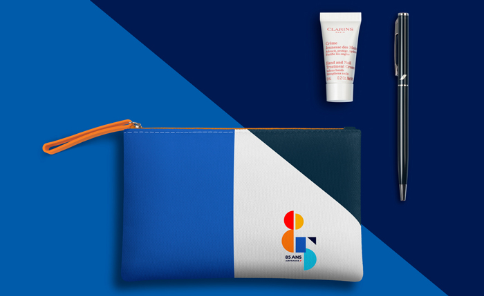 a blue and white bag with a small tube of cream