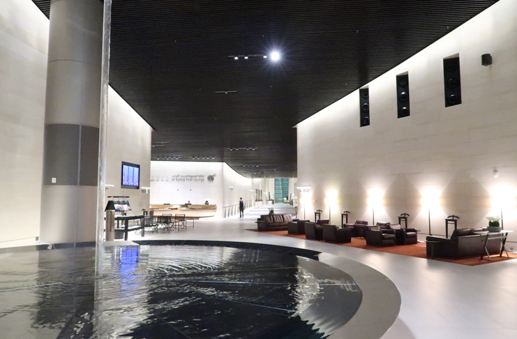 a room with a pool and a large wall