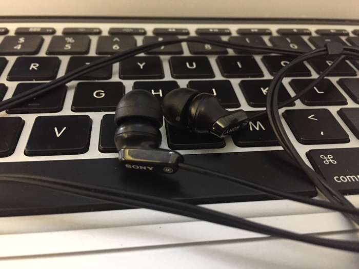 a pair of earbuds on a keyboard