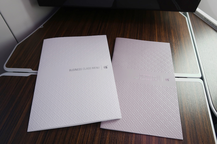 a couple of white folders on a wood surface