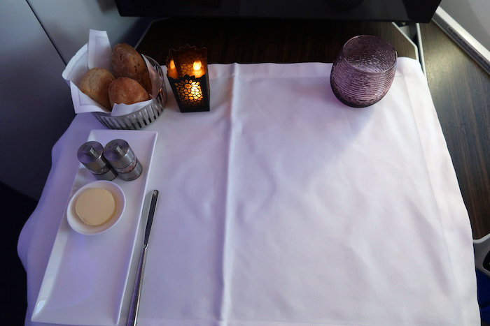 a table with a white tablecloth and a plate of food