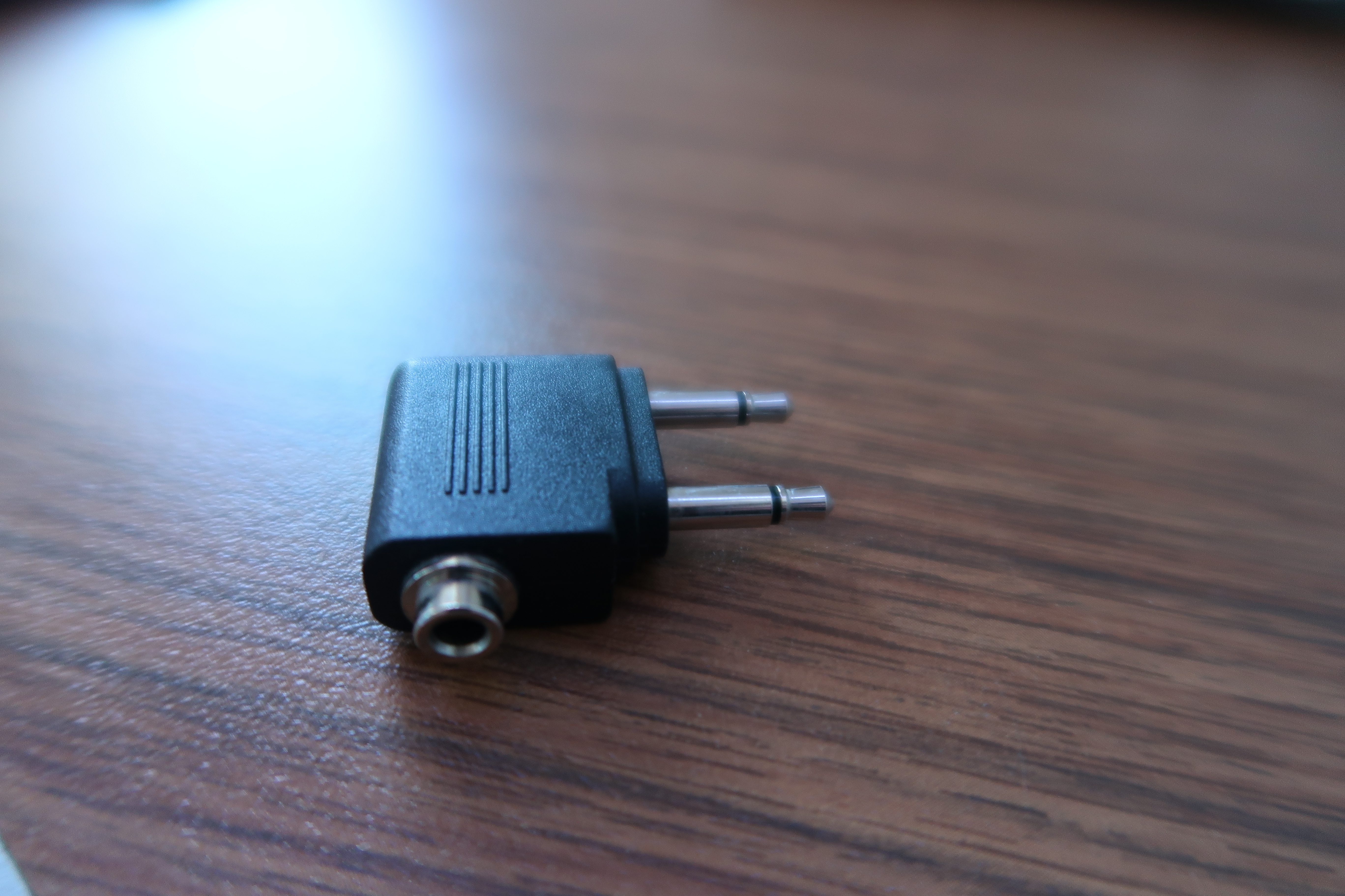 a black adapter on a wood surface