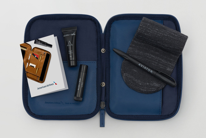 a blue and black travel bag with a few items on it