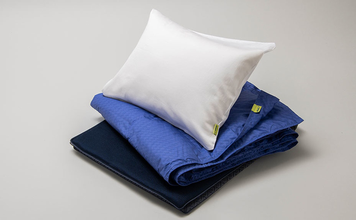 a white pillow on a blue blanket