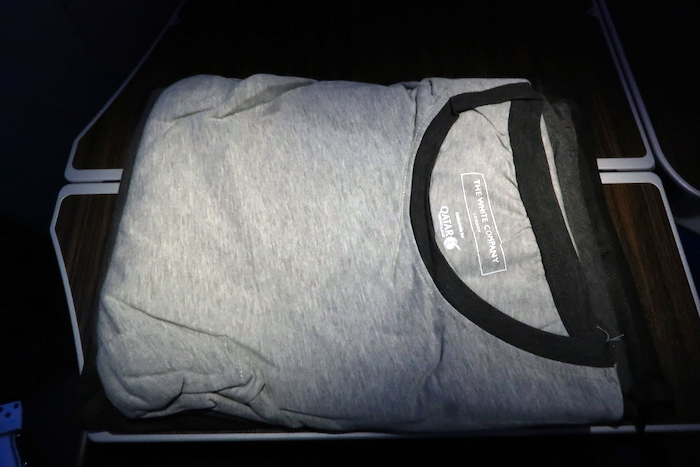 a folded grey shirt on a black surface