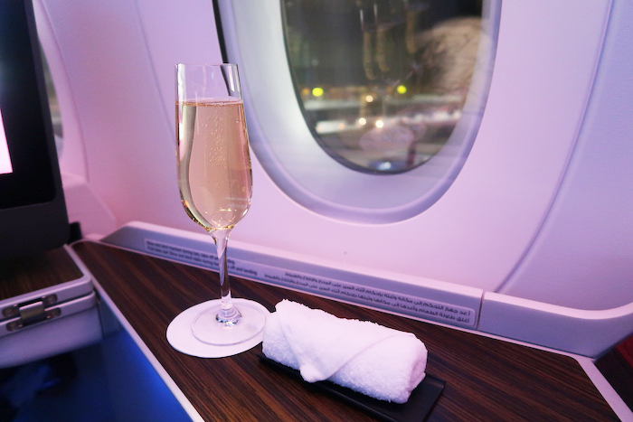 a glass of champagne on a table next to a towel