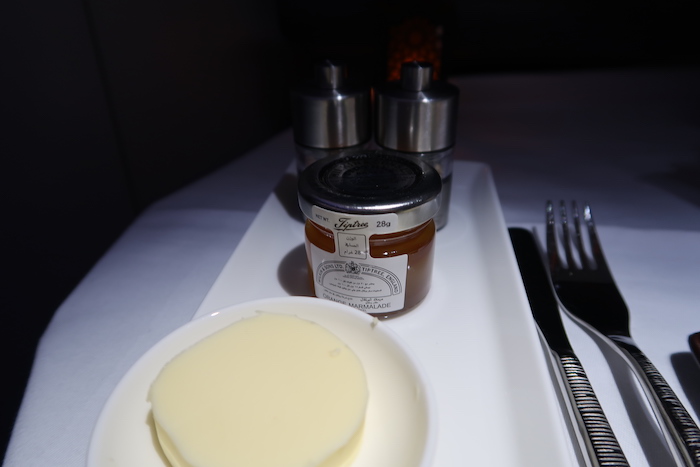 a plate of butter and a jar of butter on a tray