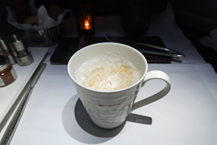 a white mug with a brown liquid in it
