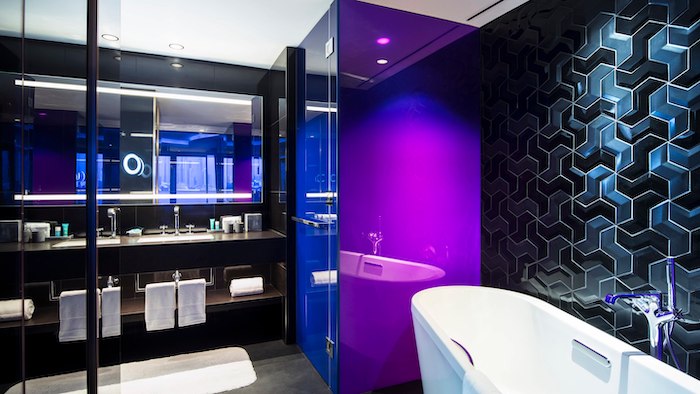 a bathroom with purple walls and a tub