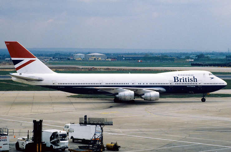 a large white and blue airplane on a runway