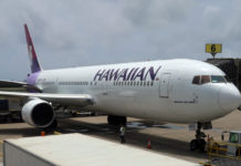 a large white airplane with purple lettering on it