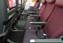 Qantas Economy Plus: How much and who gets free access? a row of seats in an airplane