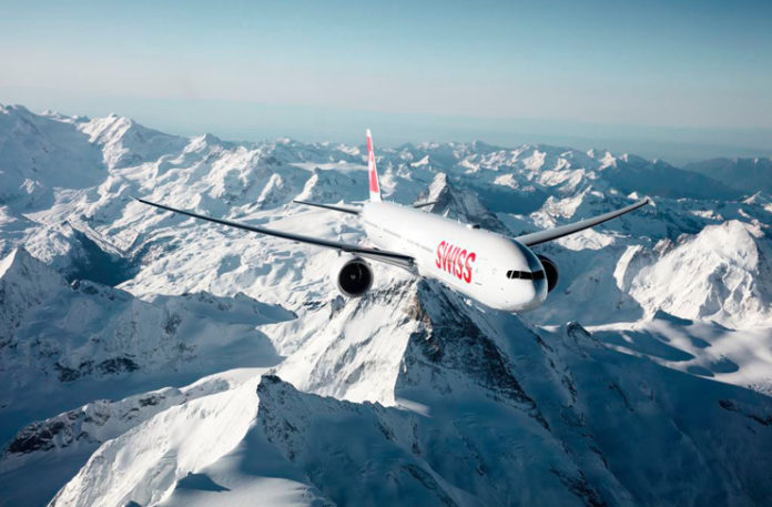 a plane flying over snowy mountains