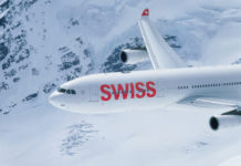 a plane flying over snow covered mountains