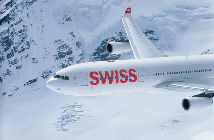 a plane flying over snow covered mountains