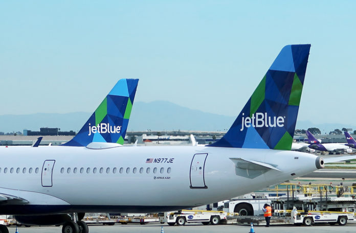 a jet blue and green tail fin of an airplane