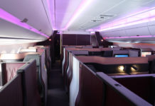 an inside of an airplane with purple lights