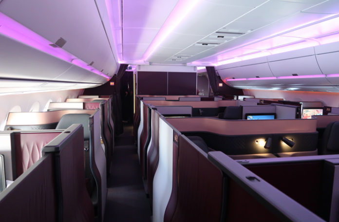 an inside of an airplane with purple lights