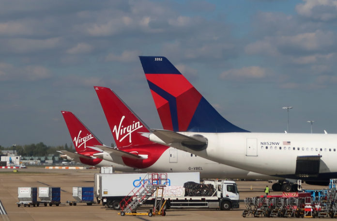 a group of airplanes parked on a runway