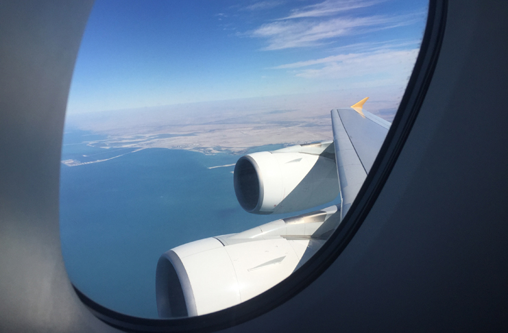 an airplane wing and engine seen from a window