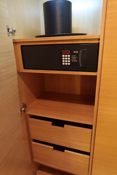 a black safe on a wooden shelf