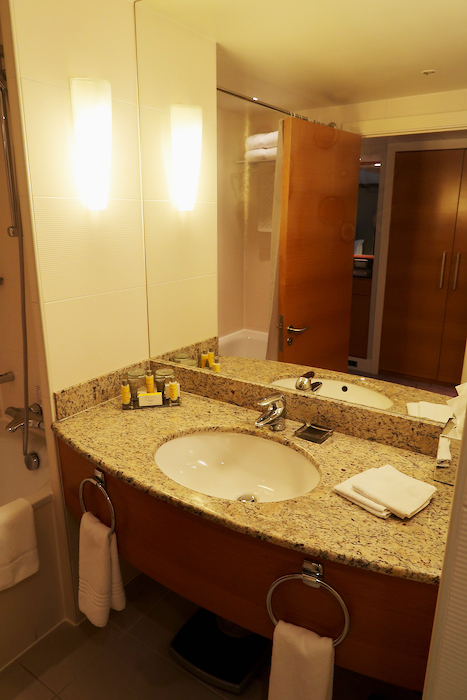 a bathroom with a marble countertop and a mirror