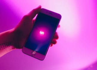 a hand holding a cell phone