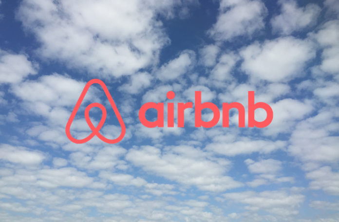 a blue sky with clouds and a logo