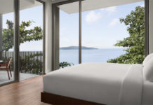 a bedroom with a view of the ocean