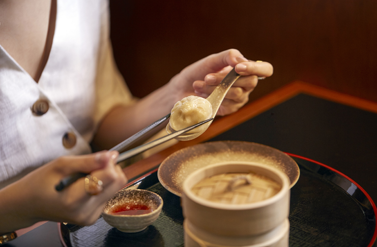 a person holding a spoon with food on it