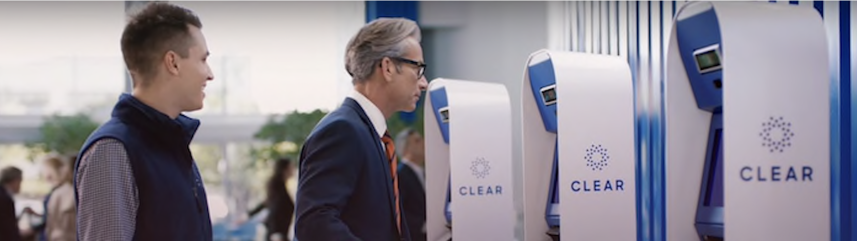 a man in a suit standing next to a machine