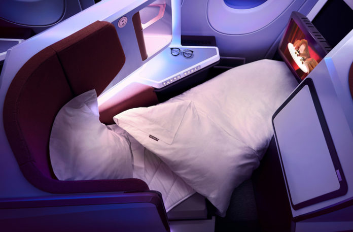 a bed and pillows in a plane
