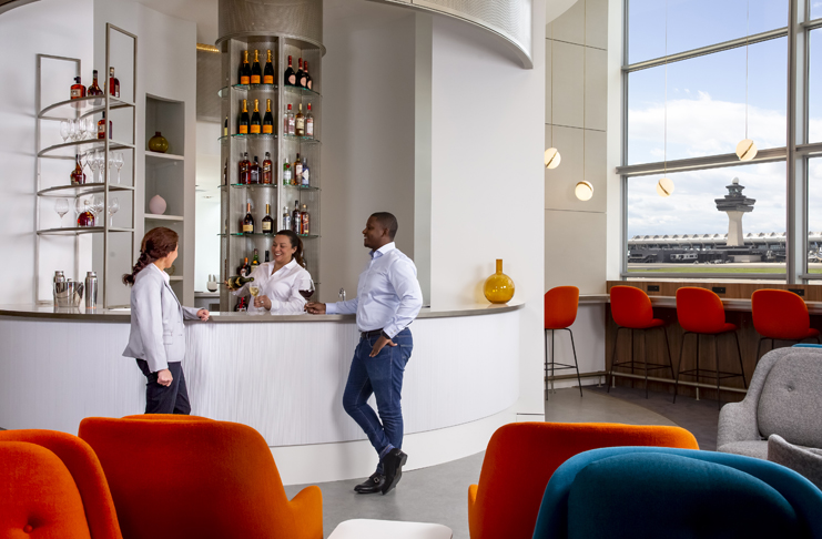 a group of people standing at a bar