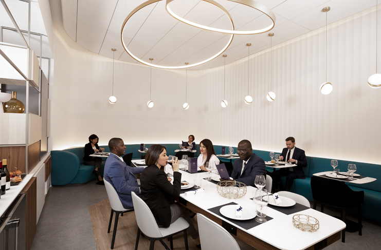 a group of people sitting at tables in a restaurant