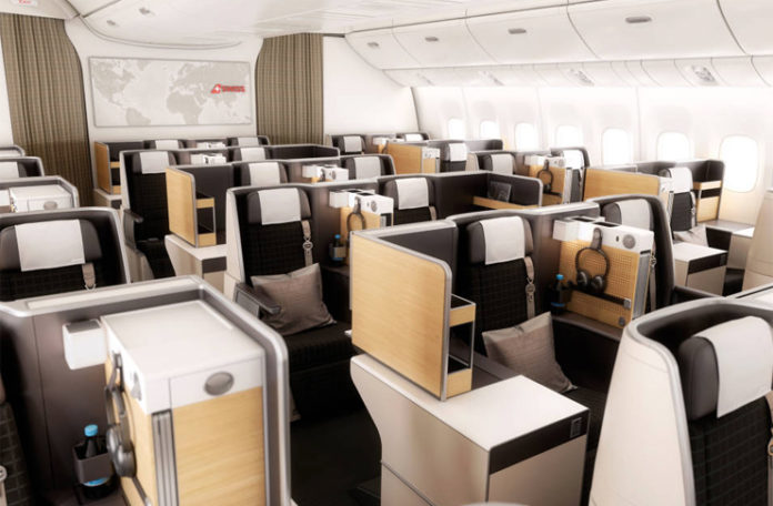 an airplane cabin with seats and tables