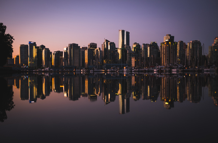 a city skyline with boats in the water