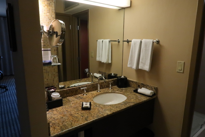 a bathroom with a marble countertop and a mirror