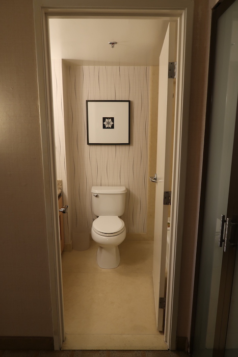 a bathroom with a picture on the wall