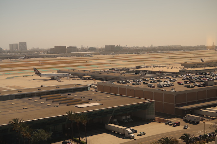 an airport with a lot of cars and buildings