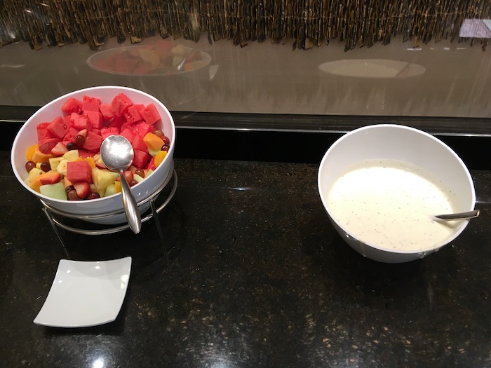 a bowl of fruit and a bowl of milk