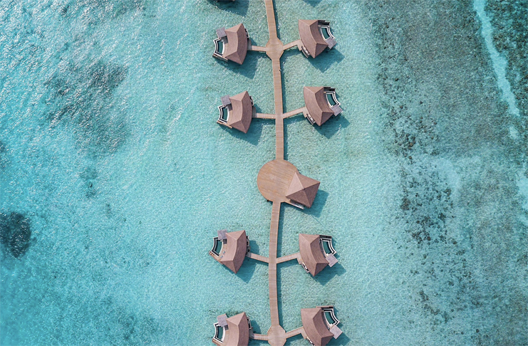 a group of huts on a body of water