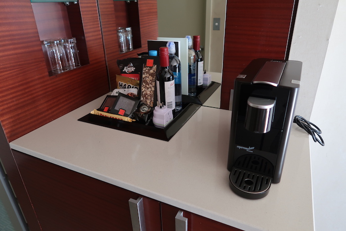 a coffee machine and a bottle of wine on a counter