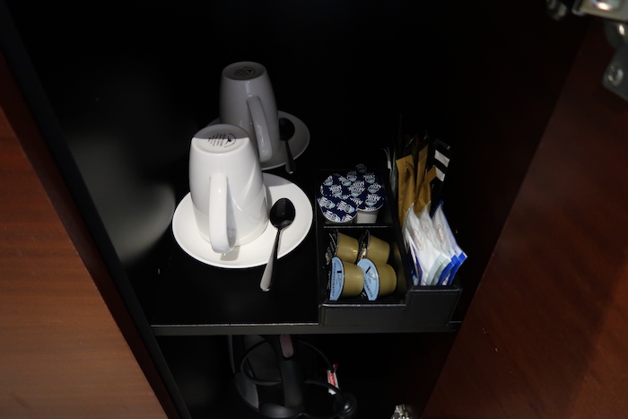 a coffee cups and saucers on a shelf
