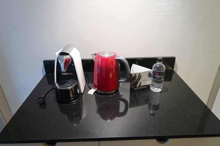 a coffee maker and a water bottle on a counter